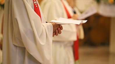 Priest holding papers